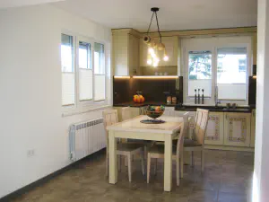 Visiting Deni's Home – two-level lime kitchen with painted details and a cleaner modern living room, photo 2